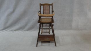 A Victorian beech framed metamorphic child's high chair with fold down tray converting to play