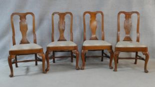 A set of four Queen Anne style fruitwood dining chairs with shaped vase splats above drop in seats