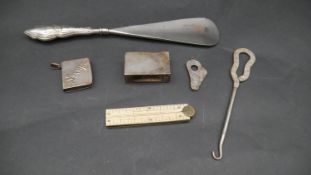 A collection of silver items. Including a silver handled shoe horn, an ivory and brass measure