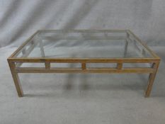 A limed oak coffee table with inset plate glass top. H.40 L.120 W.80cm