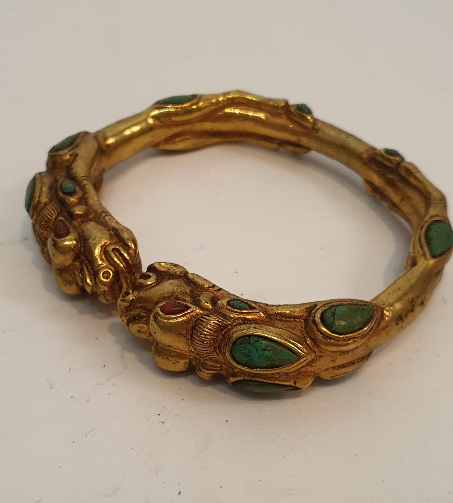 A Tibetan gilded bronze two headed dragon bangle inset with turquoise and red stone cabochons for - Image 3 of 4