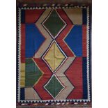 A Persian Kashkai Kilim with central diamond medallions in bold polychrome within geometric triple