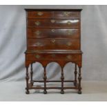 A Queen Anne walnut and feather banded chest on stand with two short and three long graduated