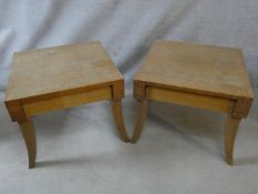 A pair of contemporary light oak bedside tables on sabre supports with maker's plaque to the inside.