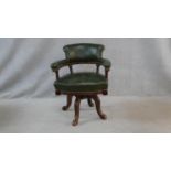 A 19th century mahogany framed captain's swivel desk chair in leather upholstery on quadruped