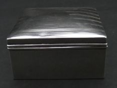 A cedar lined silver cigarette box with linear engine turned decoration. Hallmarked: AZ for A & J