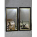 A pair of late 19th century oak wall mirrors in moulded oak frames with gilt slips. H.79 W.40cm