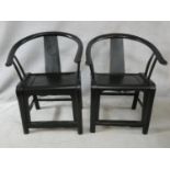 A pair of antique Chinese hardwood hooped back armchairs on rounded stretchered supports. H.90cm