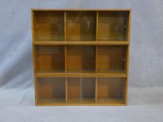 Three mid century vintage teak Unix sectional stacking bookcases with twin glass sliding doors and