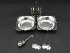 A collection of silver and silver plate items. Including a toast rack, two floral design dishes a