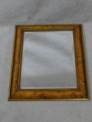 A bevelled wall mirror in burr elm moulded frame. H.58 W.48cm