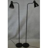 A pair of adjustable spotlights on full height metal stands. lH.165cm