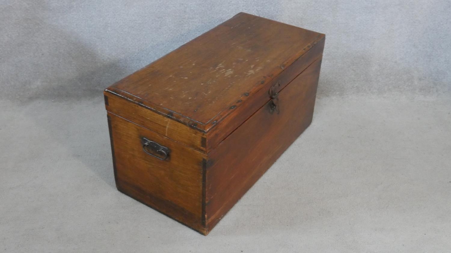 A 19th century camphor hinged lidded travelling trunk with twin iron carrying handles. H.40 W.77 D. - Image 4 of 7