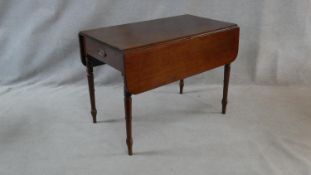 A 19th century mahogany Pembroke table with frieze drawer opposing dummy drawer on turned tapering