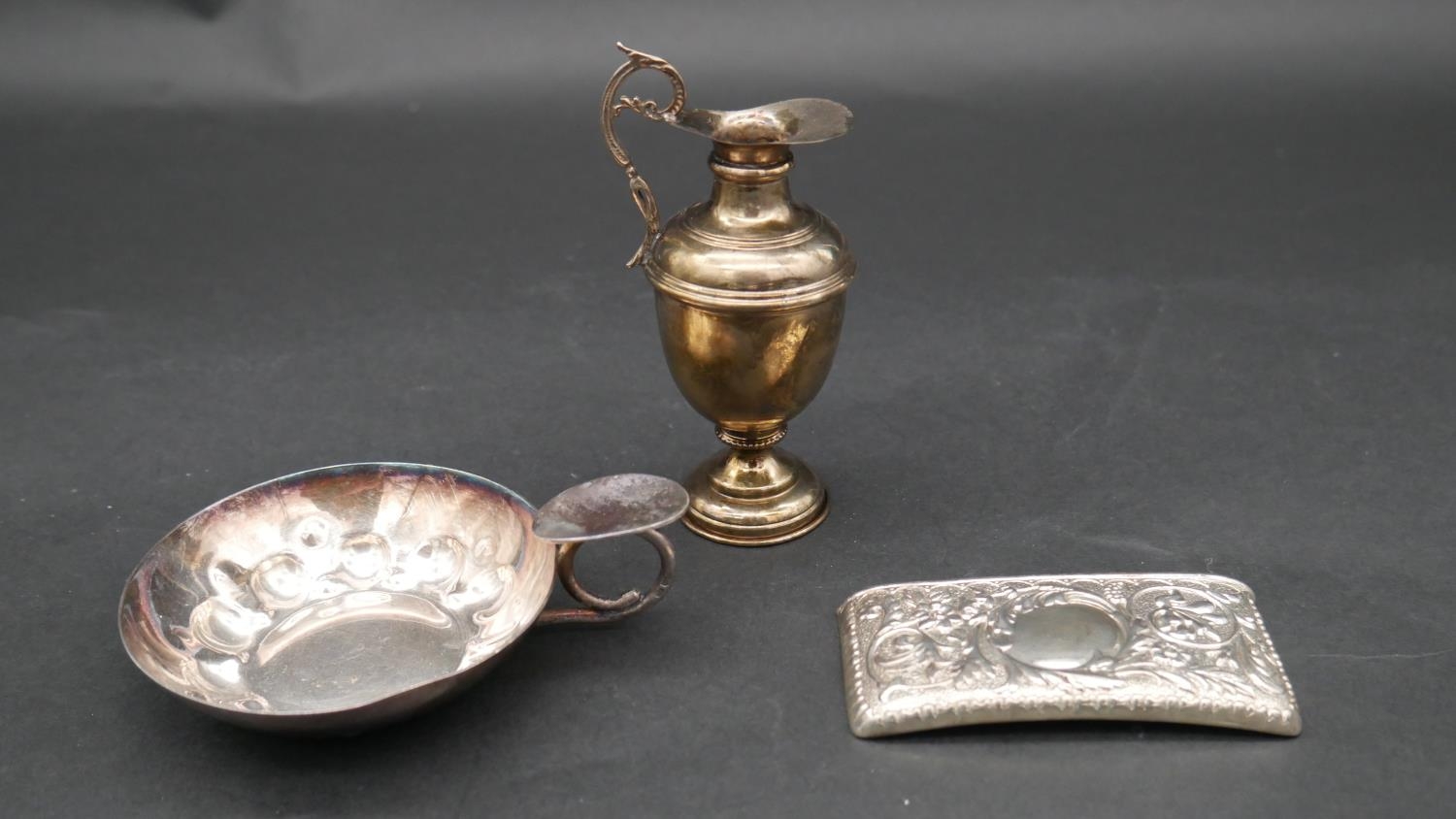 A collection of silver items. Including A miniature silver Grecian style water pitcher, a repousse