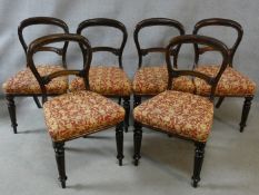 A set of six mid 19th century balloon back dining chairs with stuffover seats in floral upholstery