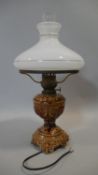 A table lamp with milk glass shade and ceramic base, converted from a 19th century oil lamp. H.52cm