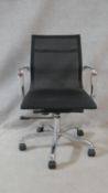 An Eames style office desk armchair in black mesh on swivel, tilt and rise and fall base. H.100cm.