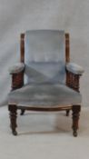 A 19th century mahogany framed armchair in buttoned upholstery on turned tapering supports. H.95 W.