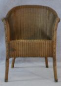 A vintage Lloyd Loom woven tub armchair with maker's label to the underside. H.70cm