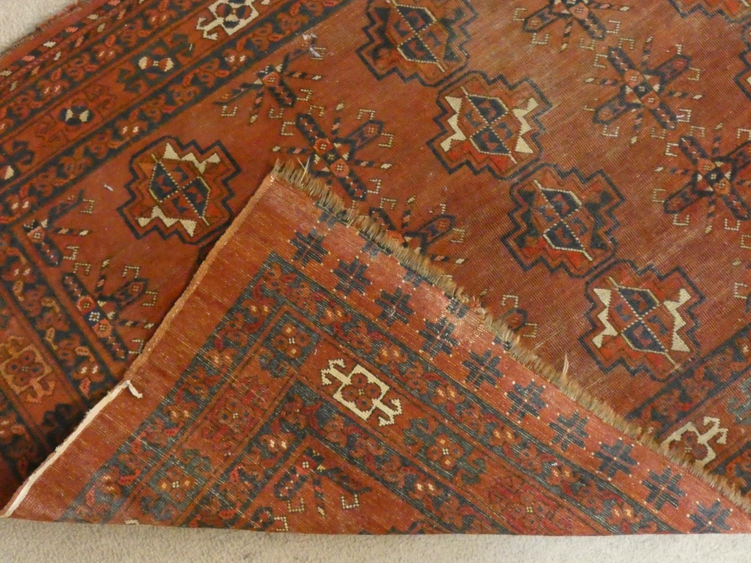 A Shirvan rug with repeating gul motifs across the madder ground contained by multiple stylised - Image 4 of 4