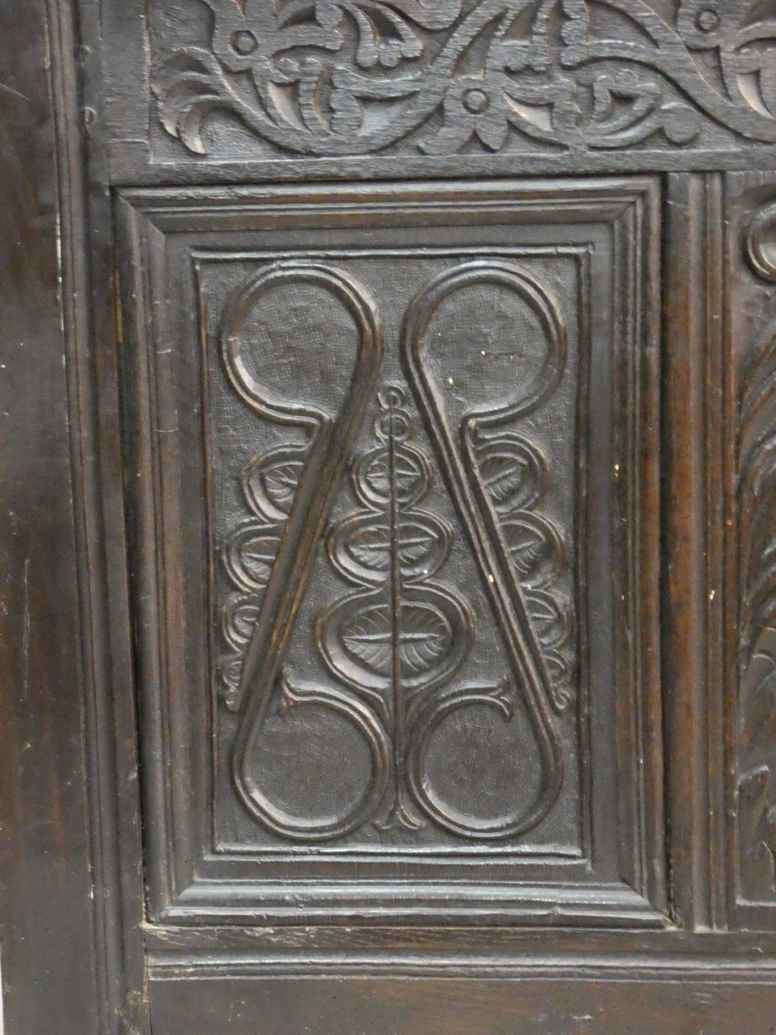 An antique country oak coffer with hinged lid above floral carved panels on block feet. H.75 L.136 - Image 4 of 9