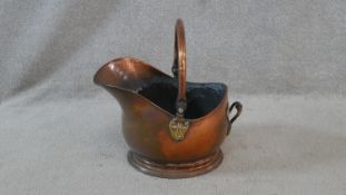 A 19th century brass and copper helmet shaped coal bucket. H.39cm