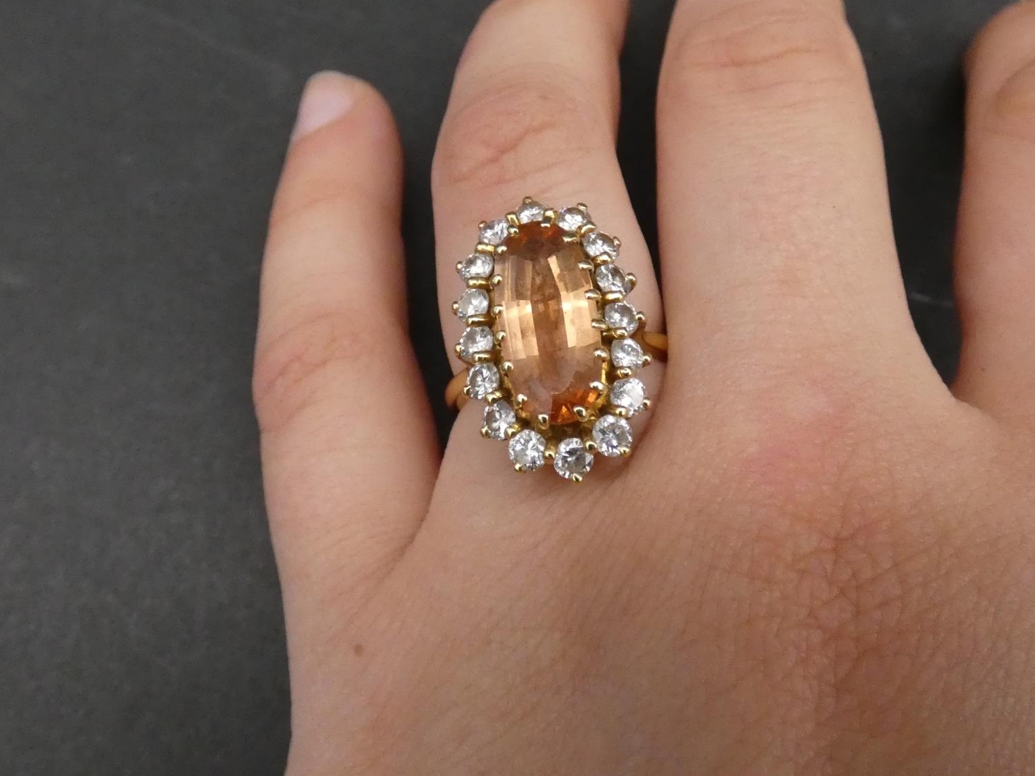 A vintage 18ct yellow gold topaz and diamond oval cluster dress ring. Set with an oval mixed cut - Image 2 of 3