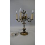 A vintage brass four branch table candelabra with spread eagle finial. H.52cm