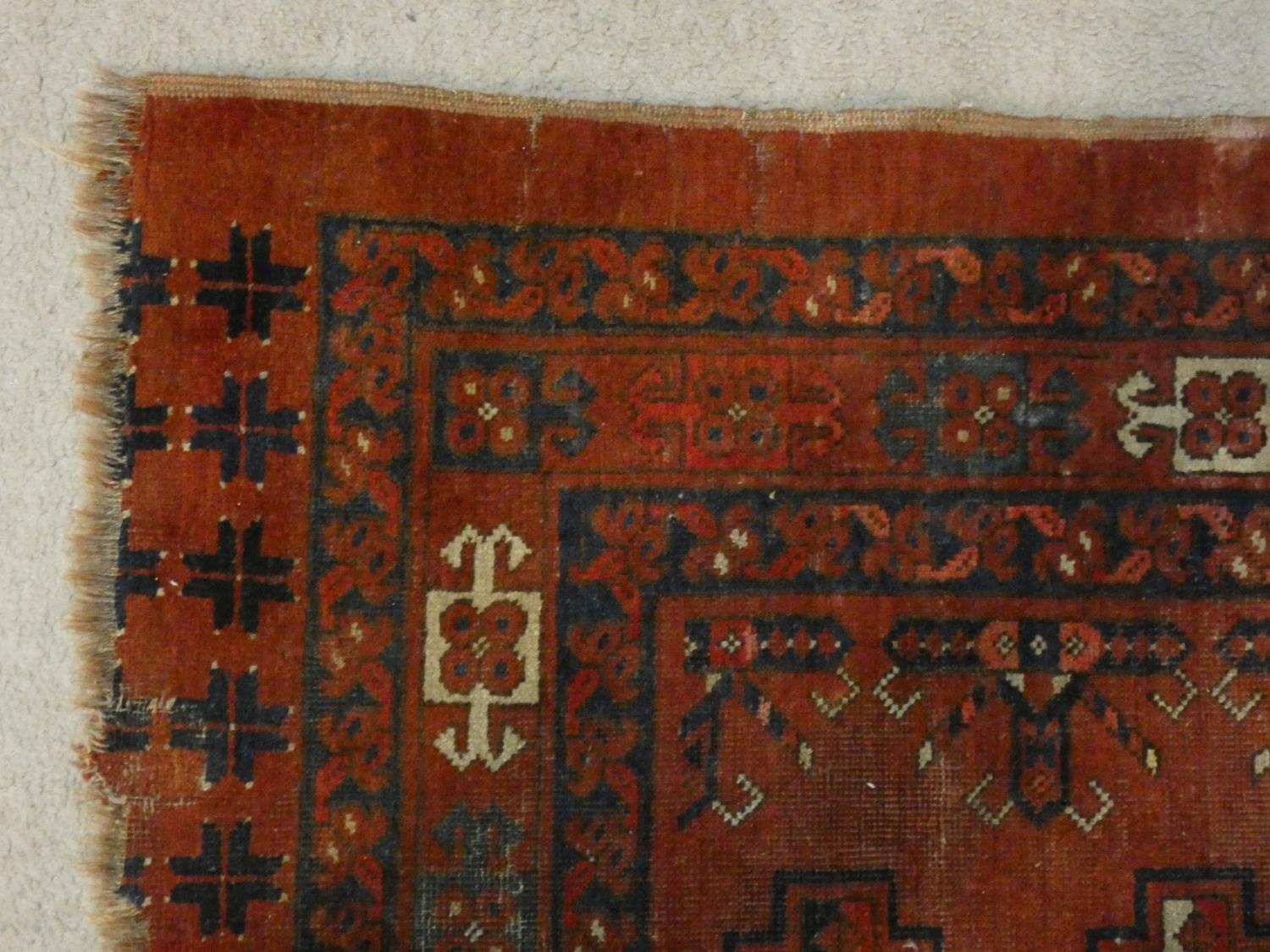 A Shirvan rug with repeating gul motifs across the madder ground contained by multiple stylised - Image 3 of 4