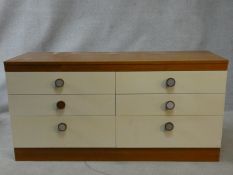 A 1960's vintage teak bank of six drawers with maker's label to the inside. H.69 W.138 D.45cm