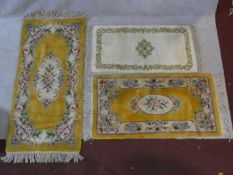 Two Chinese rugs with floral decoration on golden ground and a Persian style rug. L.160 W.78cm