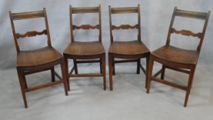 A set of four 19th century country fruitwood bar back dining chairs with panel seats on square