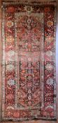 An antique Persian Malayer rug with central lozenge medallion within a broad naturalistic foliate