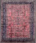 A Persian Sarogh style carpet with meandering vine, lotus flower and palmette decoration across