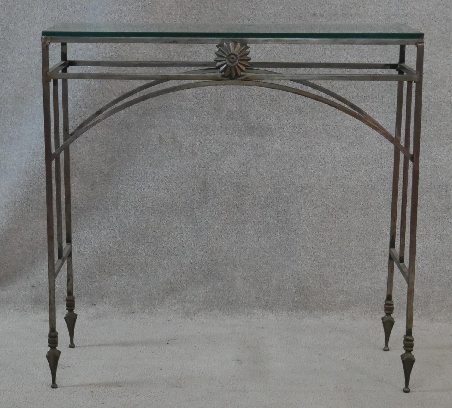A Neoclassical style wrought iron console table with plate glass top. H.75.5 L.76 W.29cm