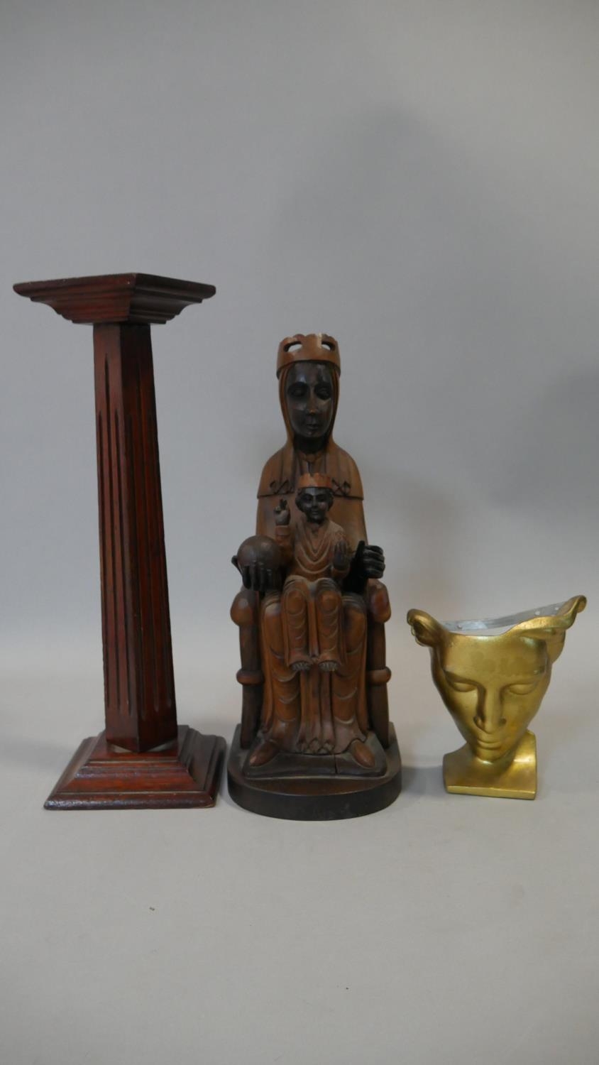 A gilt metal mask on stand with impressed marks to the back, a medieval style carving and a