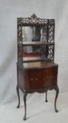 A late 19th century mahogany mirror backed side cabinet with Chinese style pierced shelved upstand