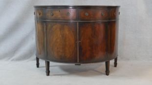 A C.1900 Georgian style mahogany demi lune side cabinet with section veneered and crossbanded top