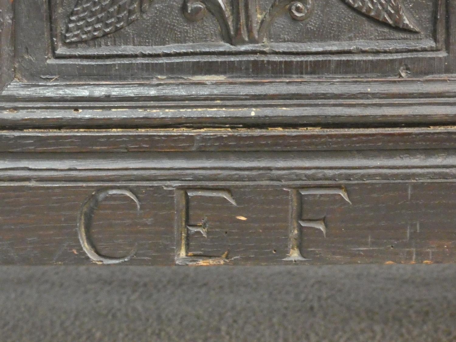 An antique country oak coffer with hinged lid above floral carved panels on block feet. H.75 L.136 - Image 7 of 9