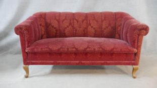 A two seater Chesterfield style sofa in cut floral upholstery on cabriole supports. H.80 W.160 D.