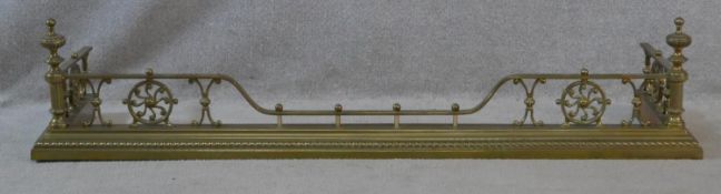 A 19th century brass fire fender with reeded shaped finials on stepped base. H.29 L.134 W.37cm