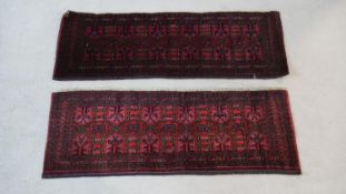 A pair of small Eastern rugs with repeating gul medallions within floral multiple borders. L.122 W.