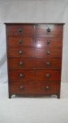 A Regency tall mahogany chest of four short over four long drawers with original brass lion's mask