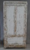 A vintage distressed painted hall cupboard with panel door enclosing linen shelves on block feet.