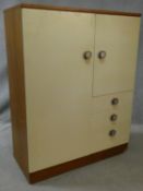 A 1960's vintage teak compactum wardrobe with fitted hanging space, cupboard with slide out vanity