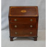 An Edwardian mahogany and satinwood crossbanded bureau with patera inlaid fall front revealing