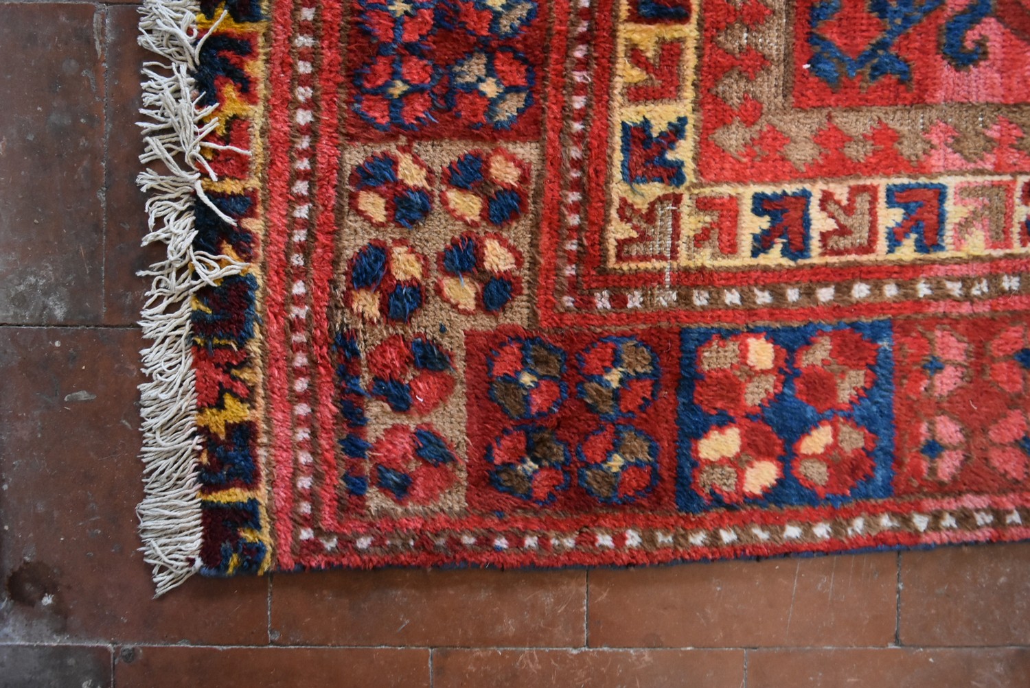 An antique Tabat carpet with repeating gul motifs across the deep red field contained within a - Image 3 of 4