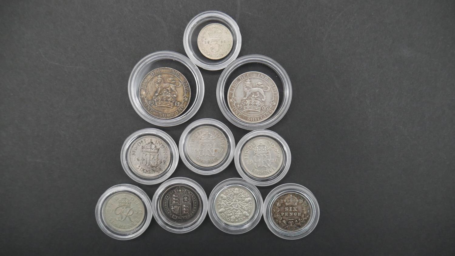 Ten silver coins in capsules. Including 1906 and 19012 silver one shilling coins, seven silver