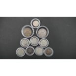 Ten silver coins in capsules. Including 1906 and 19012 silver one shilling coins, seven silver